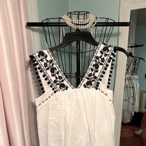 J. Crew white blouse with navy blue embroidery.